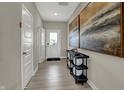 Inviting foyer with wood floors, white doors, and stylish decor leading into the home at 3733 Cantebury Dr, Franklin, IN 46131