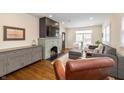 Bright living room with fireplace, built-in shelving, hardwood floors, and ample seating at 402 E 46Th St, Indianapolis, IN 46205
