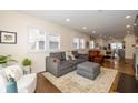 Open living area with a sofa, sitting chair, ottoman and large windows at 402 E 46Th St, Indianapolis, IN 46205