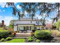 Landscaped backyard and patio with outdoor seating and views of the white two-story home at 4339 Royal Pine Blvd, Indianapolis, IN 46250