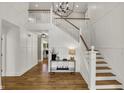 Bright foyer featuring beautiful hardwood floors, white trim, and a staircase with wood treads at 4339 Royal Pine Blvd, Indianapolis, IN 46250