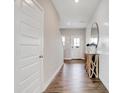 Bright entryway with wood-look floors, board and batten accent wall, and stylish console table at 4548 Laughter Ln, Indianapolis, IN 46235