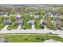 Residential neighborhood aerial view with well-maintained homes, mature trees, and green lawns under a sunny sky at 47 Thornburg Pkwy, Brownsburg, IN 46112