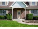 Close-up of the front door, showing brick facade and well-maintained landscaping at 4786 N Mill Ct, Greenfield, IN 46140