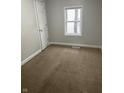 Bedroom with carpet flooring, fresh paint and a window overlooking the neighborhood at 517 W 26Th St, Indianapolis, IN 46208