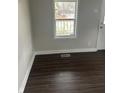 Bright living room with fresh paint, new floor and a large window at 517 W 26Th St, Indianapolis, IN 46208
