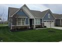 Delightful home featuring a blue exterior, verdant lawn, and an attached two-car garage for modern living at 5269 Parkhurst Xing, McCordsville, IN 46055