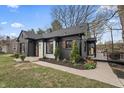 Stylish house showcasing brick and stone accents, complementing the professionally landscaped front yard and inviting walkway at 5954 Crestview Ave, Indianapolis, IN 46220