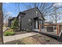 This cozy home features a well-manicured lawn, blooming flowers, and a charming covered deck for outdoor relaxation at 5954 Crestview Ave, Indianapolis, IN 46220