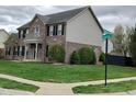 Corner lot with a two-story brick home and well-manicured lawn at 5983 Clearview Dr, Carmel, IN 46033
