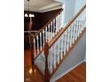 Carpeted staircase with white spindles and wooden handrail at 5983 Clearview Dr, Carmel, IN 46033