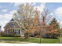 Charming home exterior showcases blossoming trees, brick accents, and a well-maintained lawn at 6645 Braemar N Ave, Noblesville, IN 46062