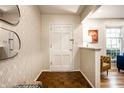 Bright entryway features hardwood floors, and neutral decor with decorative mirror at 6911 N Tuxedo St, Indianapolis, IN 46220