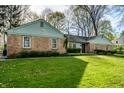 Well-maintained home featuring brick accents and a verdant, inviting front yard at 6911 N Tuxedo St, Indianapolis, IN 46220