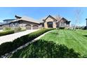 Beautiful house with a well manicured green lawn and a long driveway leading to the garage at 7128 Trail Ridge Ln, Indianapolis, IN 46259