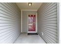 Covered porch with a red front door and neutral siding creating a welcoming entrance at 7219 Snider Ct, Indianapolis, IN 46221