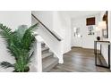 Welcoming entryway with hardwood floors and staircase and bright natural light at 7230 Estes Dr, Indianapolis, IN 46239