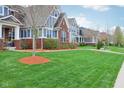 Charming street view showcases well-maintained homes with beautiful landscaping and manicured lawns in a friendly neighborhood at 7501 Independence Dr, Zionsville, IN 46077