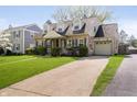 Attractive brick home with attached garage, green lawn, and concrete driveway at 908 N Bolton Ave, Indianapolis, IN 46219
