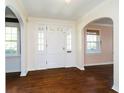 Bright foyer with hardwood floors, arched doorways, and large windows for natural light at 908 N Bolton Ave, Indianapolis, IN 46219
