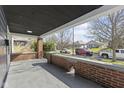 Inviting covered front porch with brick accents, offering a relaxing outdoor space with views of the neighborhood at 914 N Bancroft St, Indianapolis, IN 46201