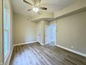 Cozy bedroom with hardwood floors, a ceiling fan, and natural light from the windows at 1001 N 14Th St, Elwood, IN 46036