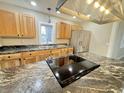 Modern kitchen featuring granite countertops, wooden cabinets, and stainless steel appliances at 1001 N 14Th St, Elwood, IN 46036