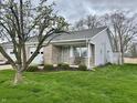 Charming single-story home with well-manicured lawn and inviting front porch at 1008 E Apple Lake Dr, Greenfield, IN 46140