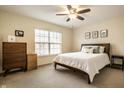 Bright bedroom with a queen-sized bed, neutral decor, and a large window allowing ample natural light at 1057 3Rd Nw Ave, Carmel, IN 46032