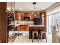 Well-lit kitchen featuring updated cabinets, stainless steel appliances, and a cozy island with seating at 1057 3Rd Nw Ave, Carmel, IN 46032