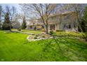 Charming stone-clad home with manicured lawn and mature trees creates inviting curb appeal at 130 Governors Ln, Zionsville, IN 46077