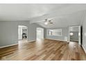 Inviting living room with wood floors, a modern ceiling fan, and an open layout to the updated kitchen at 14 Fountain Lake Dr, Greenfield, IN 46140