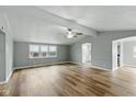 Bright living room featuring new wood flooring, neutral walls, and a ceiling fan for added comfort at 14 Fountain Lake Dr, Greenfield, IN 46140
