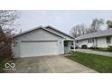 Charming single-story home featuring a gray exterior, attached garage, and well-maintained front yard at 1414 Waldemere Ave, Indianapolis, IN 46241