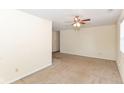 Spacious living room features neutral carpet, a ceiling fan, and ample natural light, ready for personalization and comfort at 1414 Waldemere Ave, Indianapolis, IN 46241