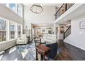 Spacious living room with soaring ceilings, large windows, and hardwood floors at 14413 Arnett Dr, Carmel, IN 46033