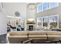 Bright living room featuring a fireplace, large windows, and a comfortable seating area at 14413 Arnett Dr, Carmel, IN 46033