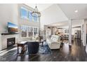 Open-concept living room showcasing a fireplace, hardwood floors, and easy access to the kitchen at 14413 Arnett Dr, Carmel, IN 46033