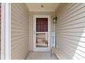 Cozy front porch with a storm door and welcome sign at 15501 Landsbrook E Run, Noblesville, IN 46060