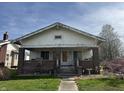 Charming home featuring a covered front porch with brick supports and a well-maintained lawn at 1625 E Thompson Rd, Indianapolis, IN 46227