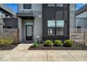 Modern home entrance showcasing clean lines, minimalist landscaping, and contemporary design at 1712 Rosette Way, Indianapolis, IN 46202