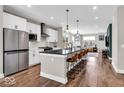 Stylish kitchen with white cabinets, stainless steel appliances, and a central island with bar seating at 1712 Rosette Way, Indianapolis, IN 46202