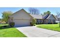 Attractive single story home with a well maintained driveway and manicured green lawn at 1927 Pheasant Way, Greenwood, IN 46143
