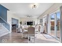 Open concept living and dining area with modern furnishings, wood floors, and sliding glass door at 19510 Pathway Point, Noblesville, IN 46062