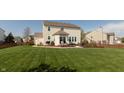 Well-maintained backyard featuring a deck, patio, and a beautifully landscaped garden, ideal for relaxation and entertainment at 2093 Autumn Faith Way, Avon, IN 46123