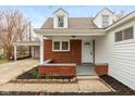 Inviting front porch with brick accents and a covered entryway at 217 Eikenberry St, Greenfield, IN 46140