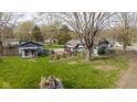 Expansive yard features a cozy guest house, mature trees, and lush green grass at 218 Miami Dr, Noblesville, IN 46062
