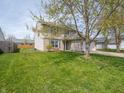 Well-kept two-story home with green lawn and partial tree cover on a sunny day at 270 Lazy Hollow Dr, Brownsburg, IN 46112