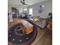 Spacious living room offers wood floors, a ceiling fan, and comfortable seating arrangements at 3101 N Temple Ave, Indianapolis, IN 46218