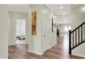 Inviting entryway with wood floors and a view into the dining and living spaces at 3572 Westmore Cir, Bargersville, IN 46106